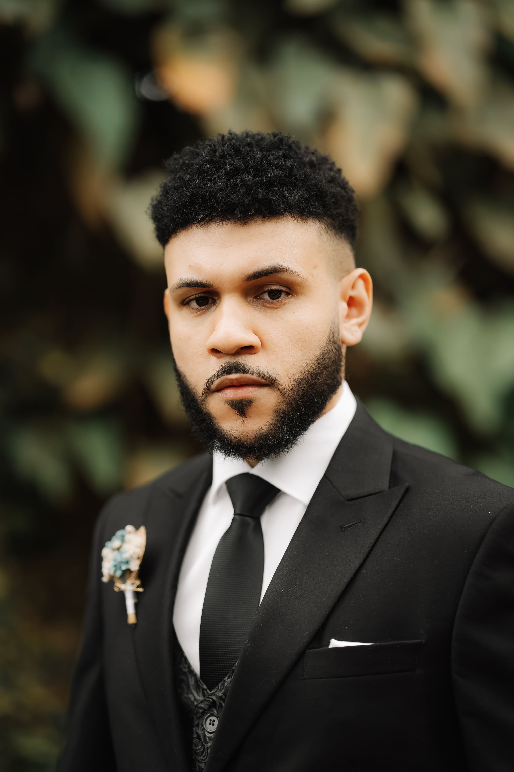 Gabriel Bomfim wearing a black suit in a professional portrait